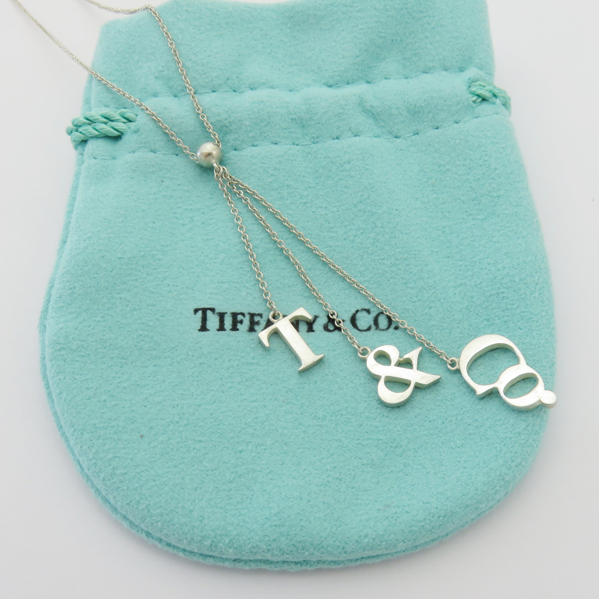 TIFFANY & CO 925 Sterling Silver T & CO Dangle Pendant Necklace with Pouch